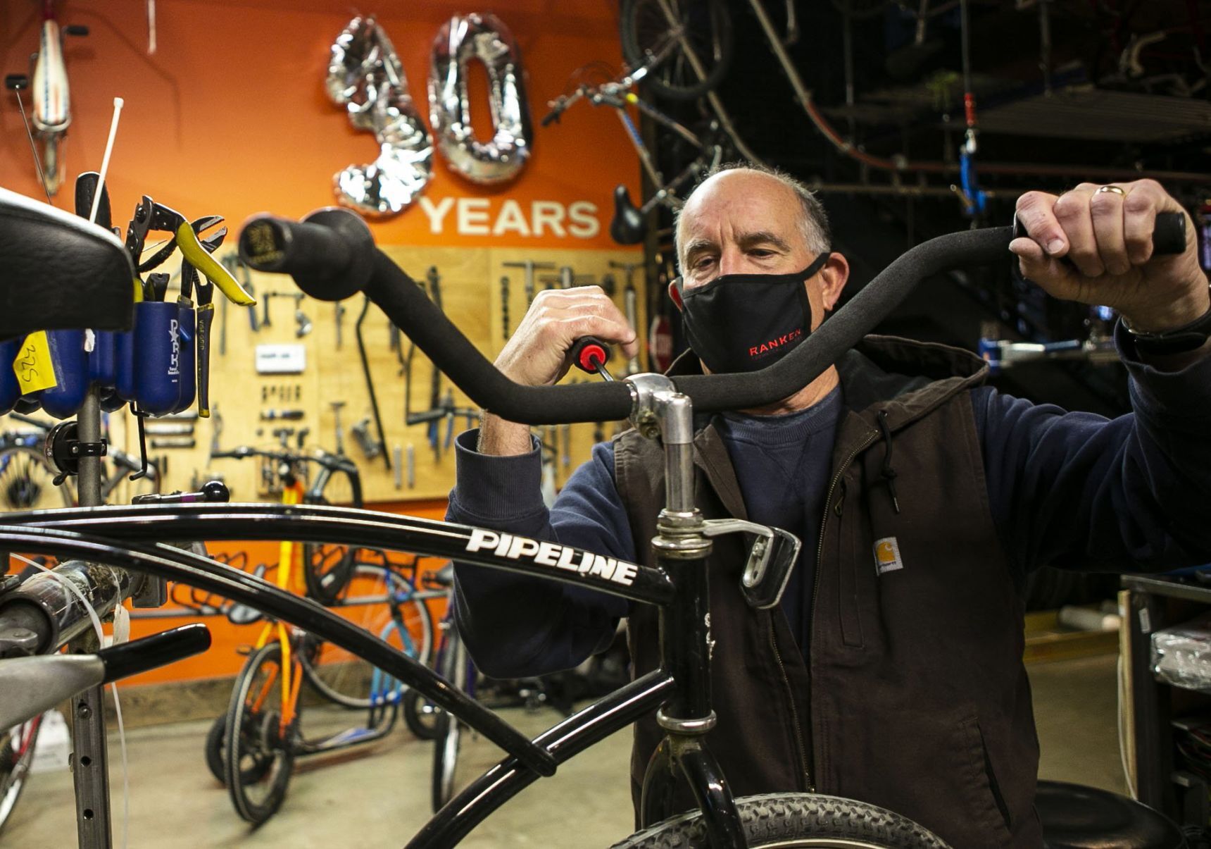 Volunteers and employees repair bikes at St. Louis BWorks in Soulard